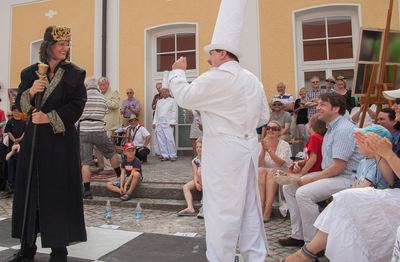 Weißer Turm reckt die Faust auf dem Feld, links der schwarze König, rechts applaudierende Zuschauer